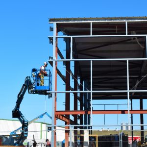 Food Sector Construction employee on a cherry picker carrying out work on a food factory or warehouse construction. This image shows what we do and illustrates what we do for our client testimonials